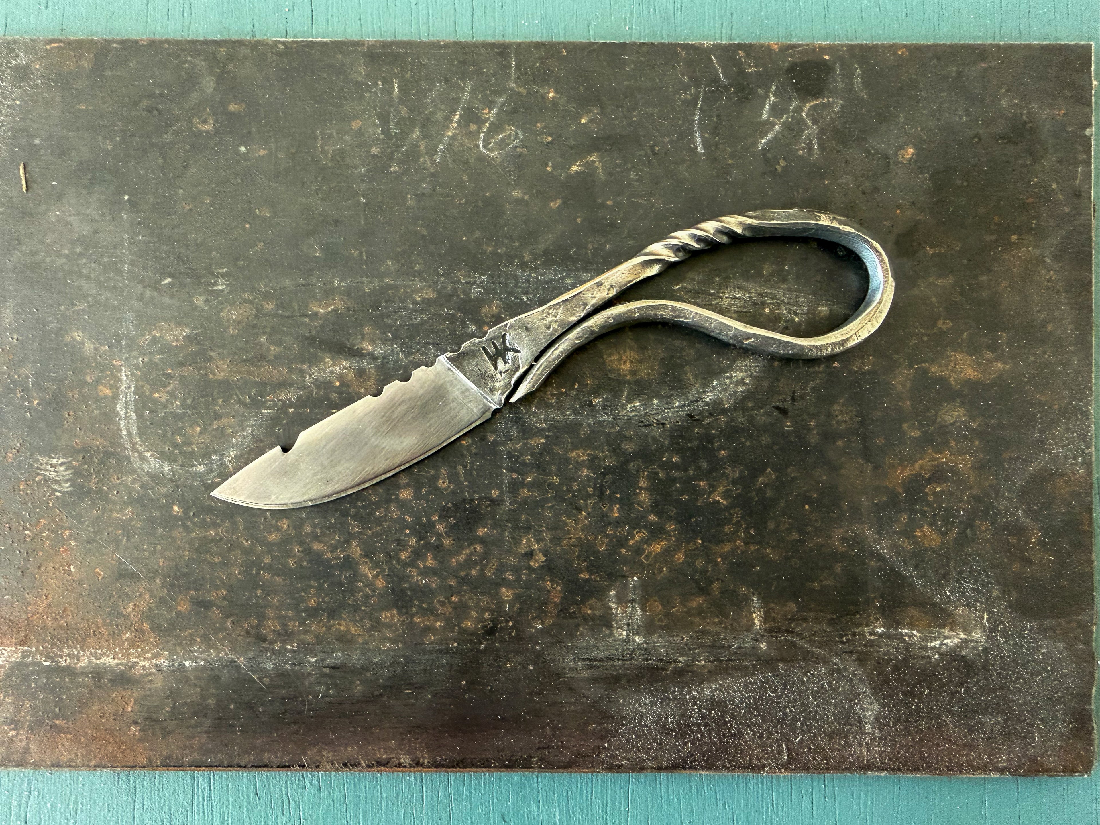 Rustic knife with decorative handle on a textured surface